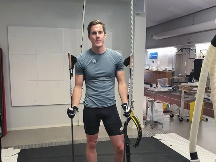 Training-clad male with ski poles