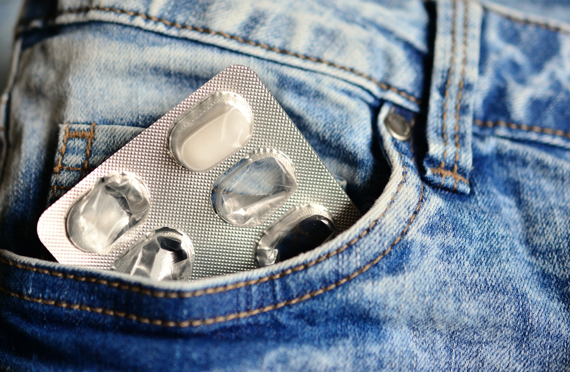 blister pack with pain-relief tablets in jeans pocket